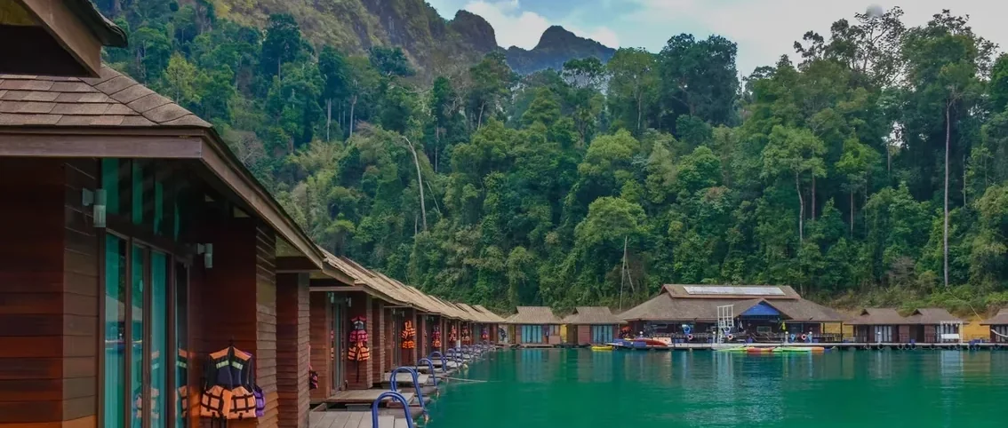 Laguna Cheow Lan Raft House floating amid limestone cliffs and emerald water in Khao Sok
