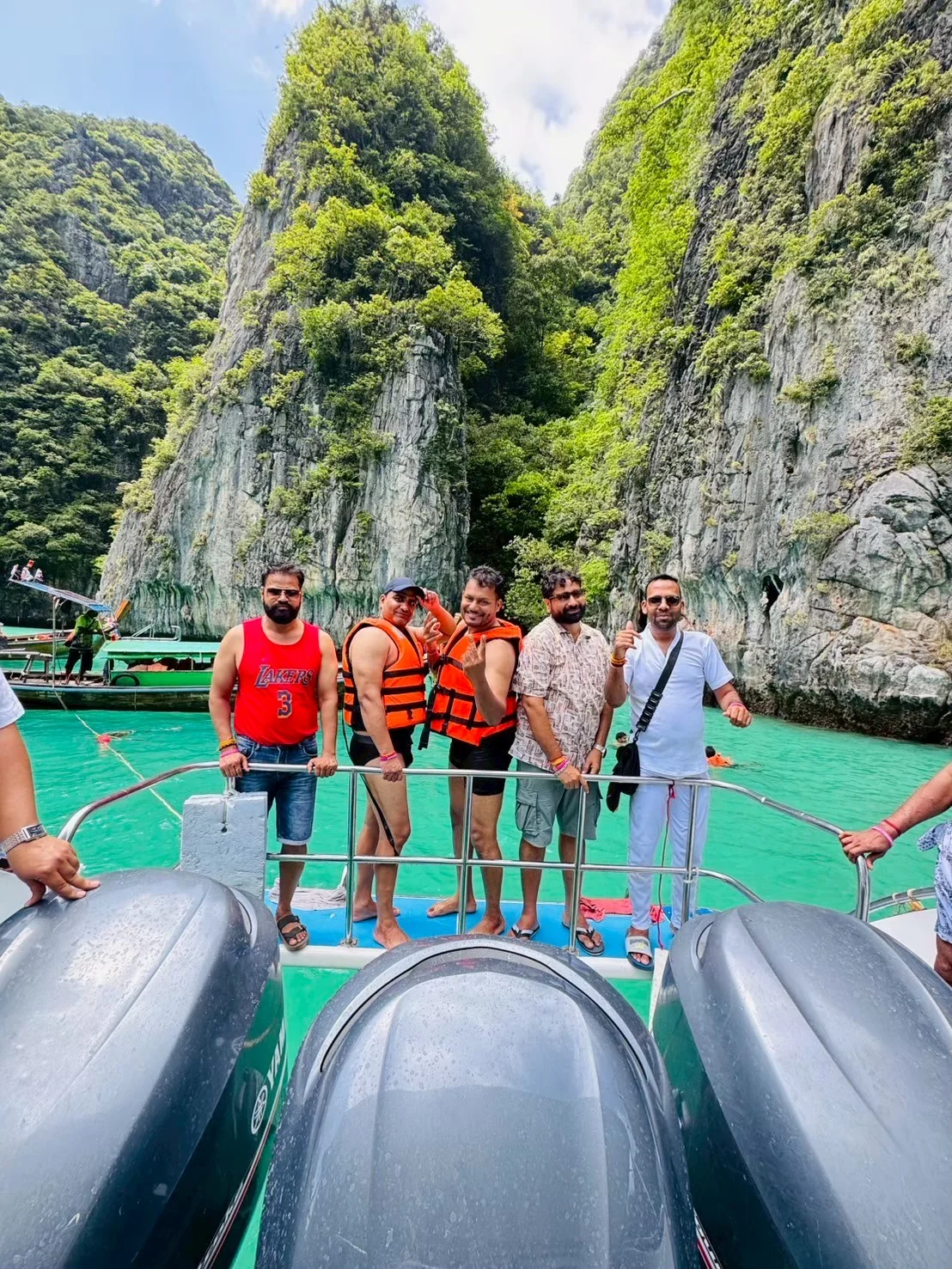 Speedboat gliding through turquoise waters near Phi Phi Island on a day tour to Maya Bay and Khai Island