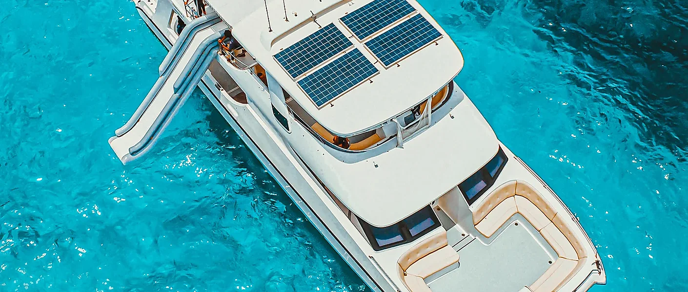 Luxury cruise boat gliding past the dramatic limestone cliffs of Phi Phi at golden dusk