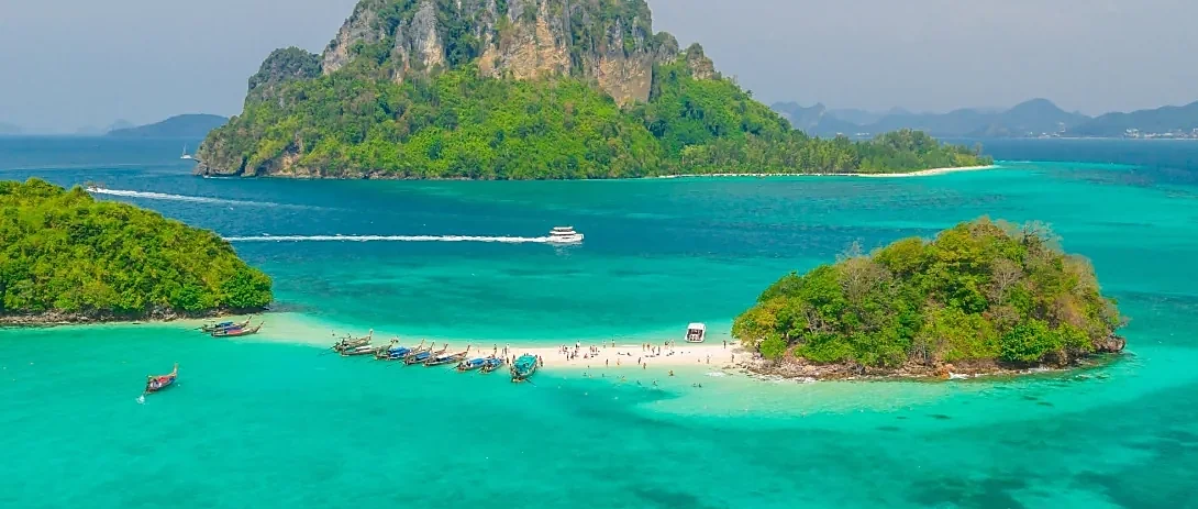 Speed boat cruising turquoise waters past Krabi's limestone islands on the 4 Island Tour