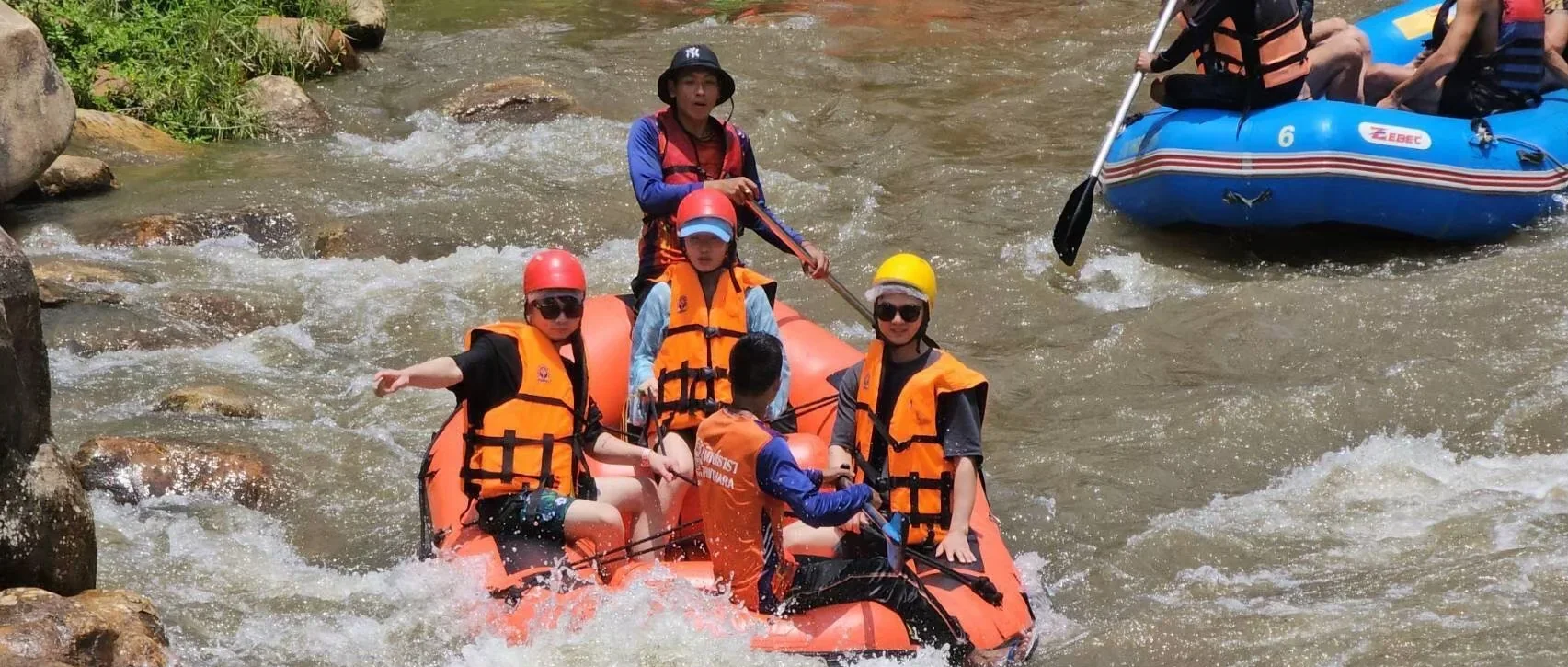 White water rafting through lush tropical scenery on an adventure tour in Phang Nga