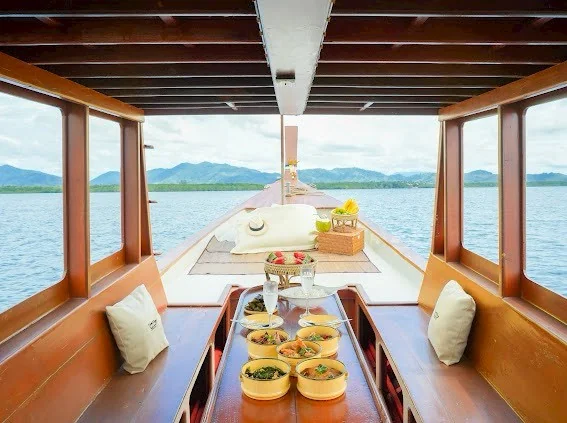 Traditional long-tail boat gliding through Phang Nga mangrove tunnels on a local life tour