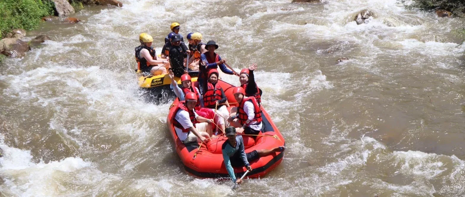 Travellers white water rafting through tropical scenery in Phang Nga