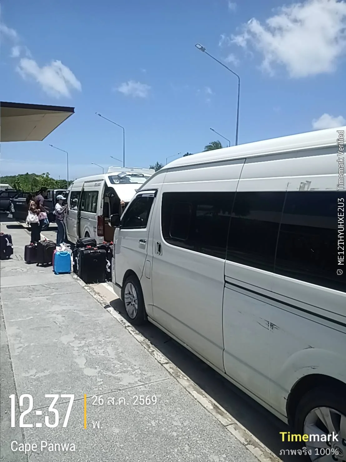 Guests with luggage boarding white transfer vans at Cape Panwa, Phuket
