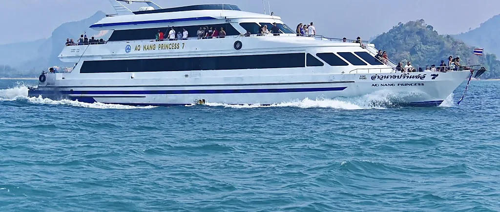Ferry crossing turquoise Andaman Sea between Ao Nang, Phi Phi Island, and Phuket on a sunny day