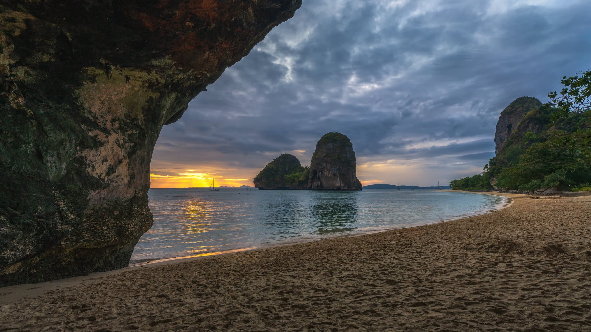 Long-tail boat off Railay Beach at sunset on a bioluminescent plankton tour in Krabi