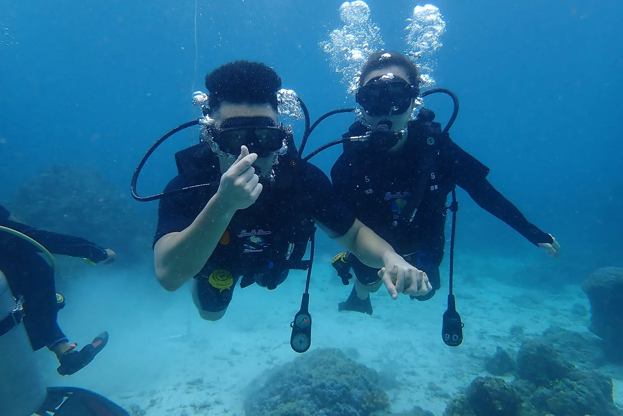 Scuba diver exploring clear waters off Racha Yai Island on a full-day diving tour
