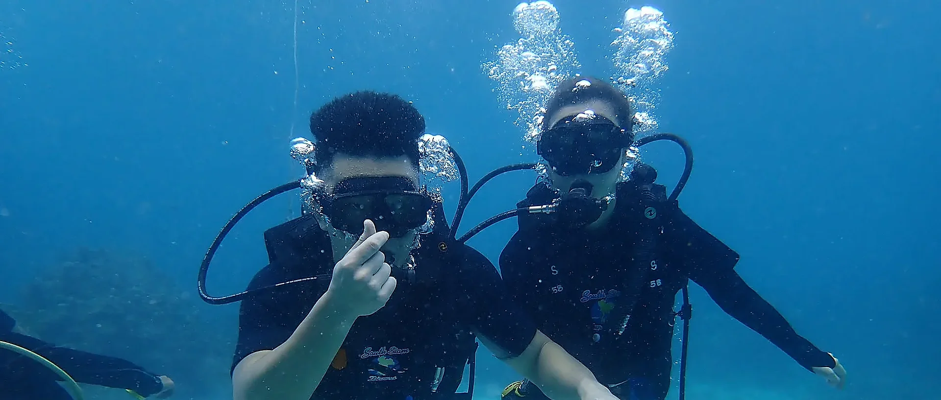 Scuba diver exploring clear waters off Racha Yai Island on a full-day diving tour