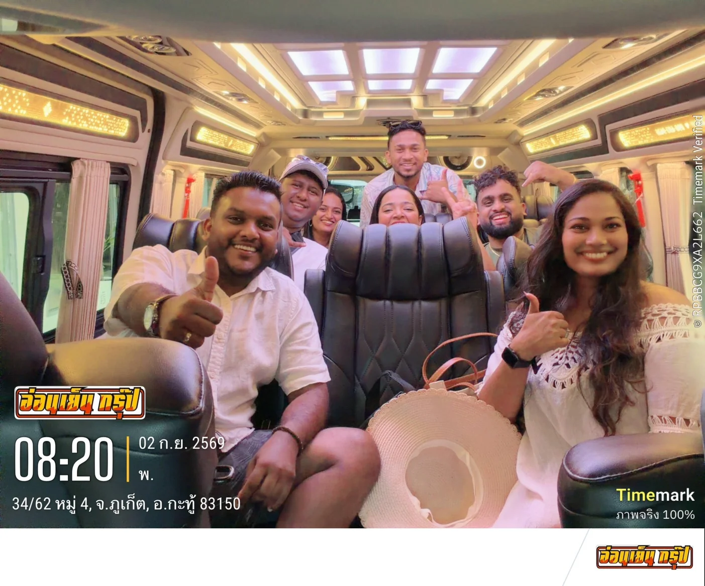 Happy travelers smiling inside a luxury tour van during a Phuket pickup