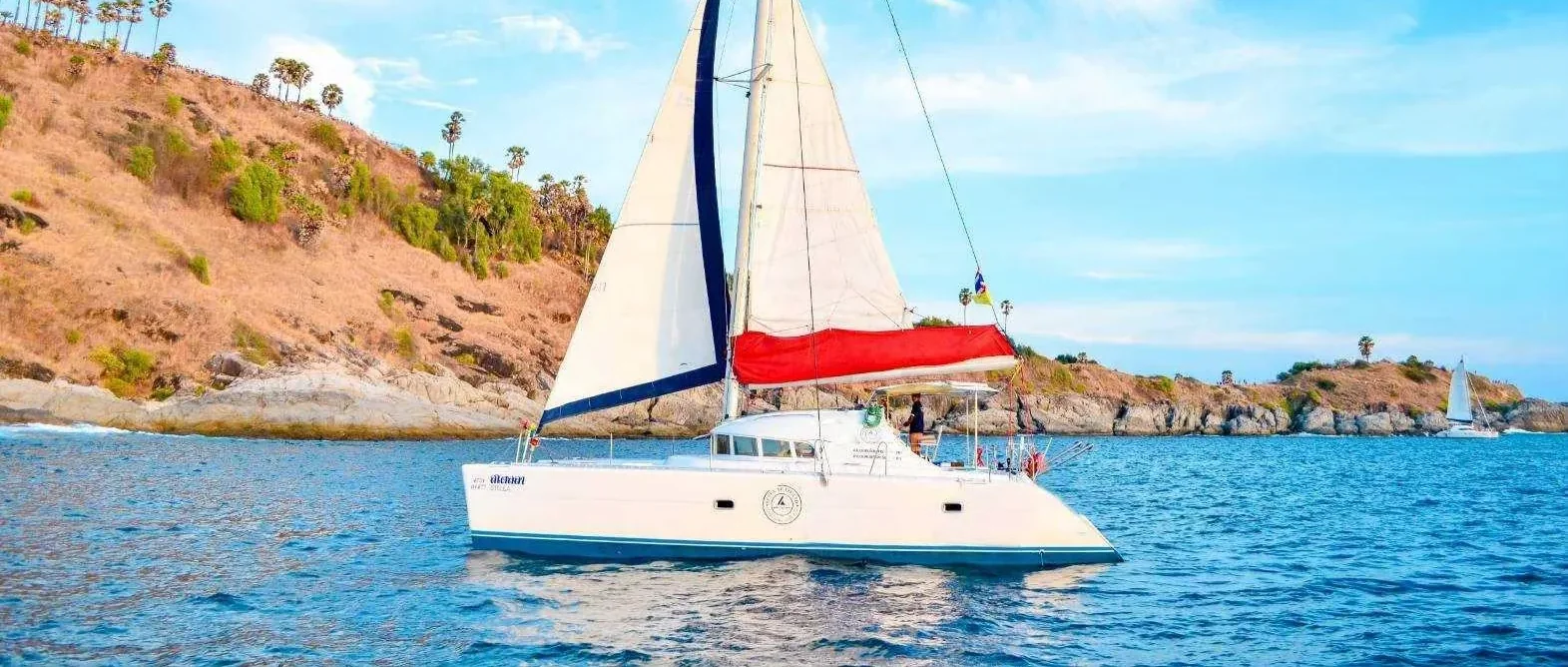 Stella Max catamaran yacht cruising off Phuket during a sunset dinner tour