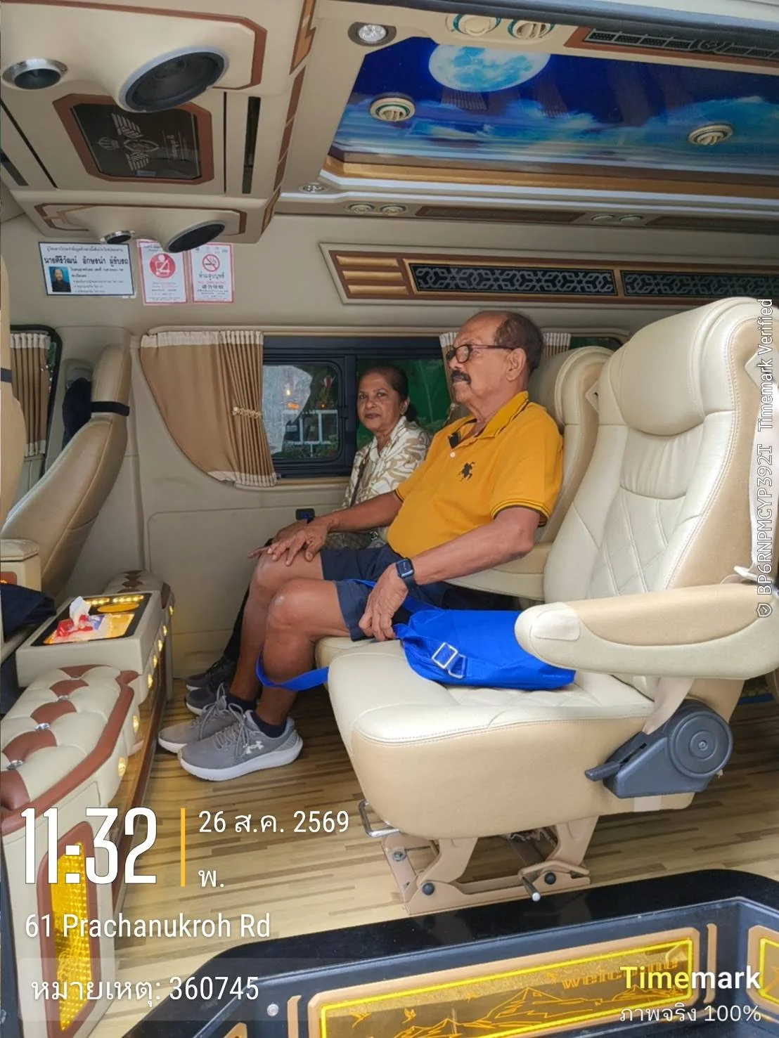 Two guests seated in a luxury tour van during a Phuket transfer on Prachanukhro Road.