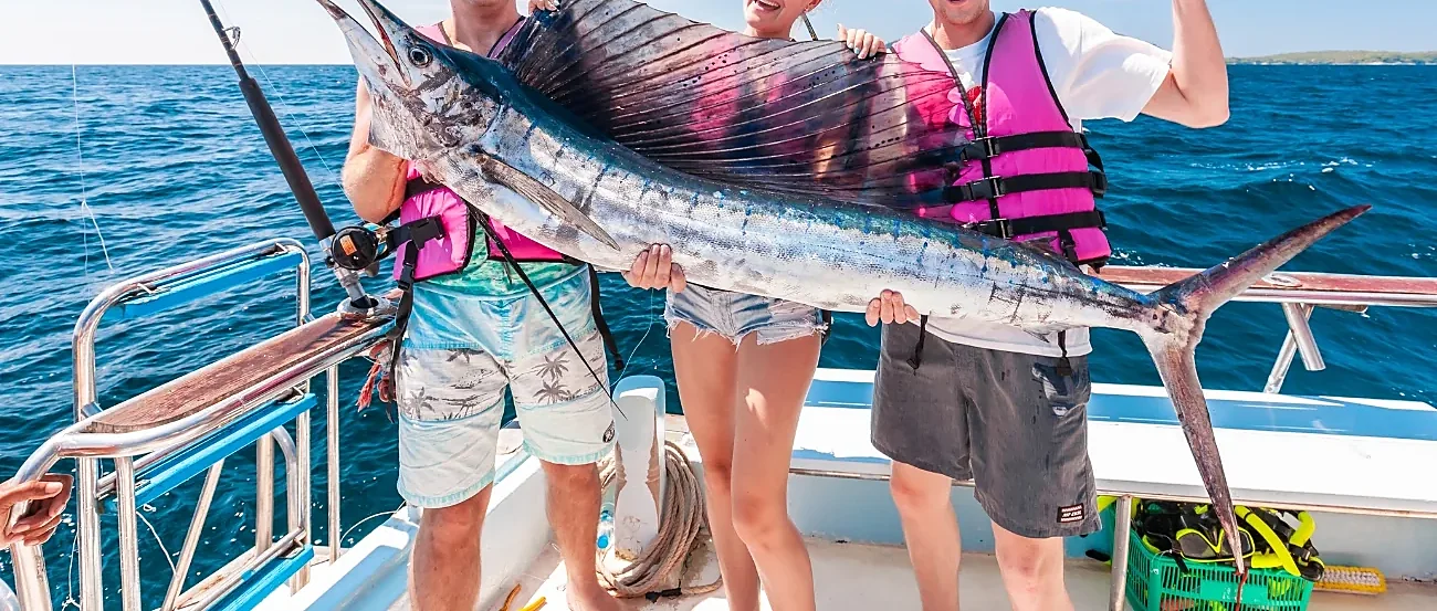 Anglers trolling and spinning for big game fish on a full-day Phuket fishing tour