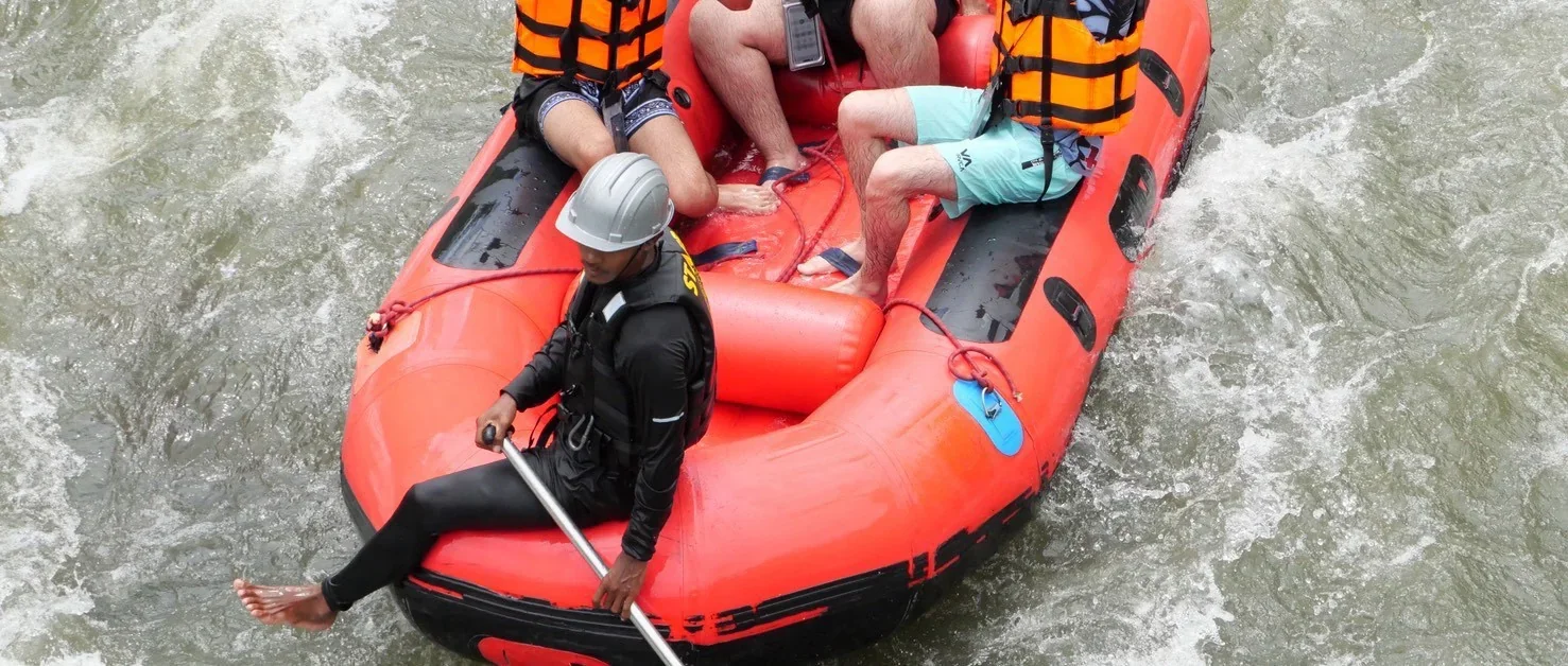 White water rafting through lush jungle rapids on an adventure tour in Phang Nga