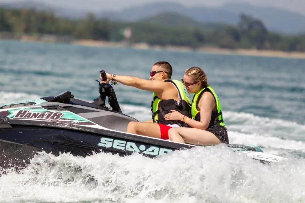 Riders exploring Phuket's tropical coastline on a Sea-Doo jet ski during a half-day island tour