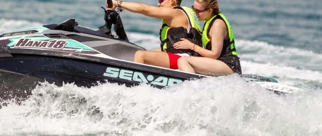 Riders exploring Phuket's tropical coastline on a Sea-Doo jet ski during a half-day island tour
