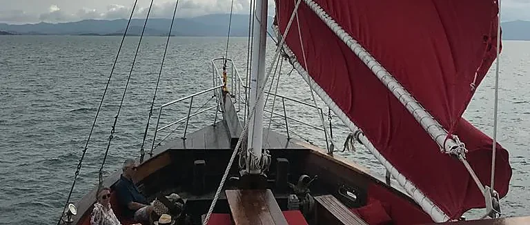 Guests enjoy dinner aboard a sunset cruise off Samui Island