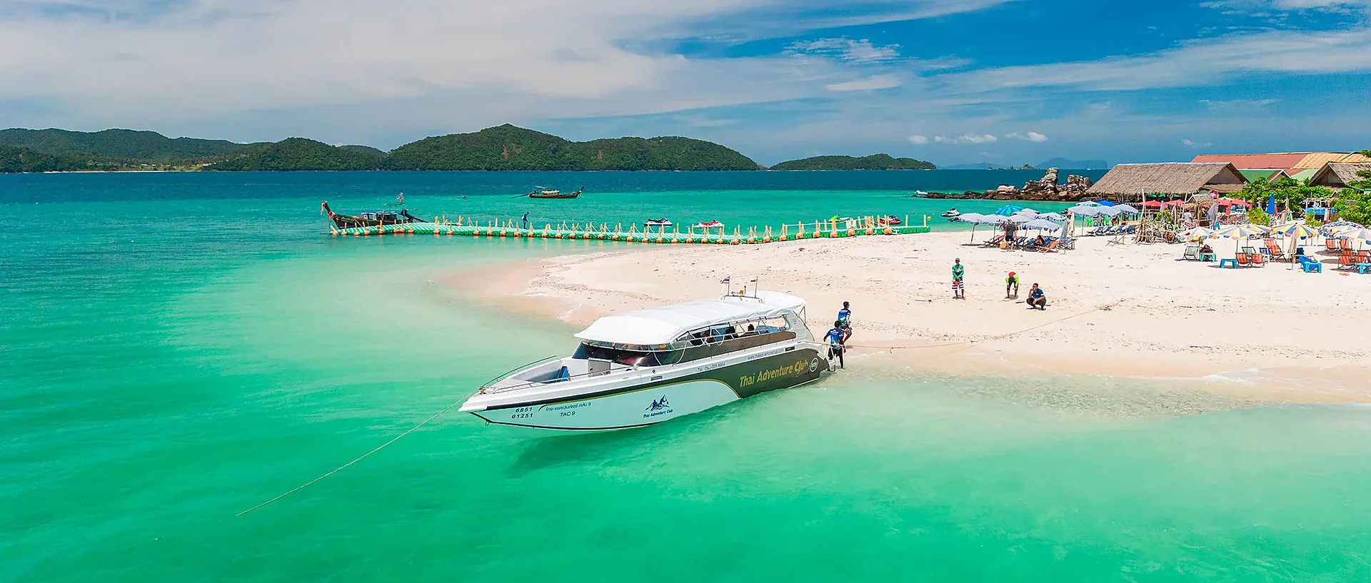 Speedboat approaching Khai Island's crystal-clear turquoise waters on a full-day tour from Phuket