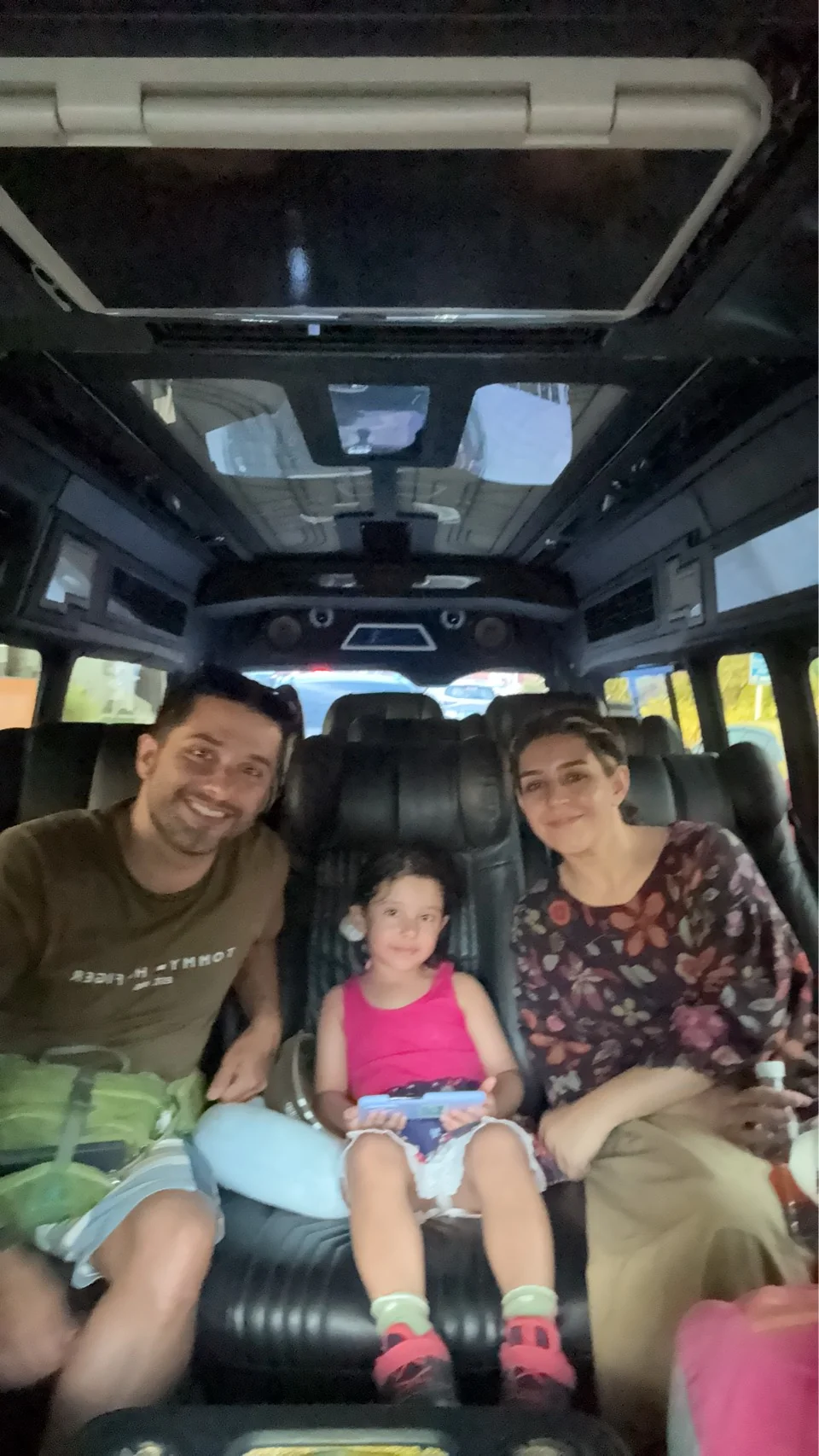 Smiling family seated inside a private tour van during a Phuket transfer