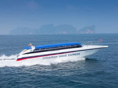 Speed boat cutting through turquoise Phuket waters on transfer route from Rassada Pier to Ao Nang