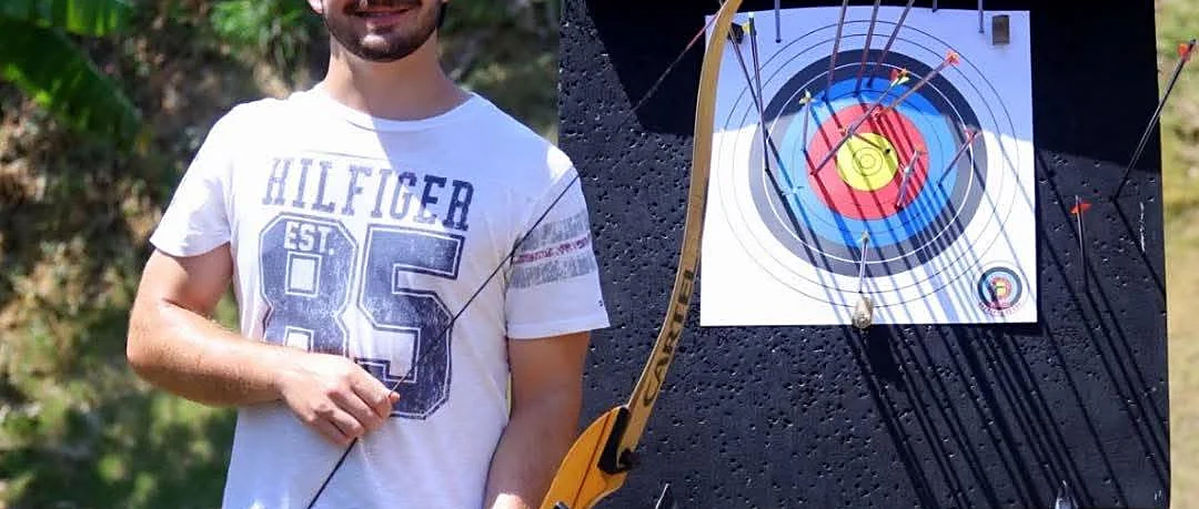 Archer aiming a bow during a 15-arrow adventure in Phuket