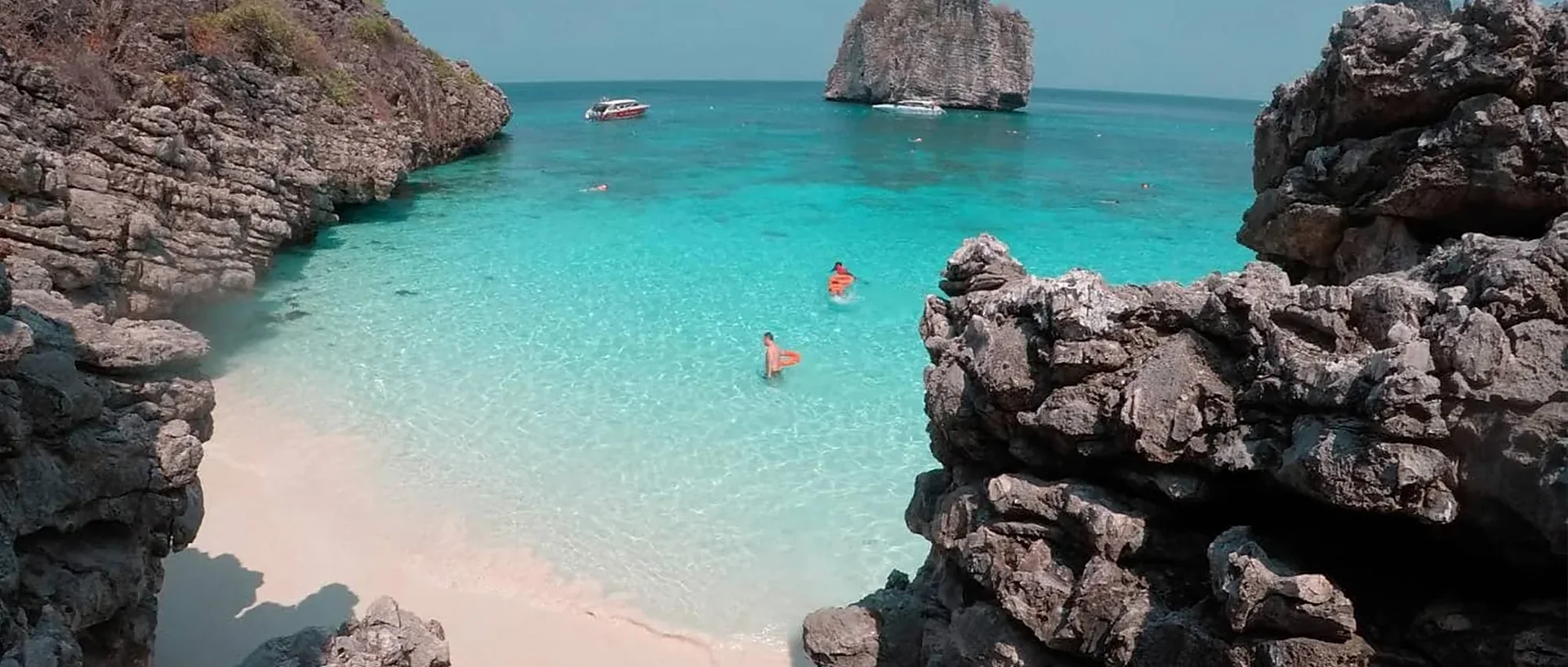 Speed boat cruising crystal-clear turquoise waters on a 4 Island tour from Lanta Island