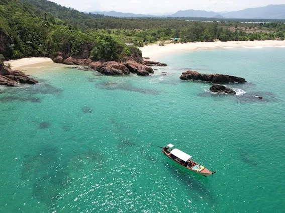 Private long-tail boat gliding through lush Khao Na Yak waterways in Phang Nga