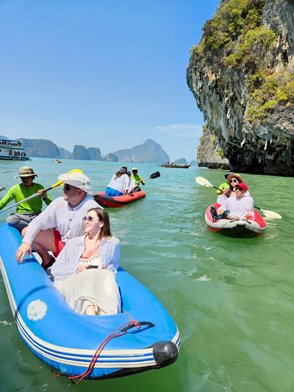 Speed boat gliding past the iconic limestone karsts of Phang Nga Bay on a James Bond Island sea canoe tour