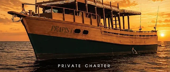 Heritage Prapis 1 private sunset cruise off Phuket, with Jacuzzi deck glowing near Promthep Cape at golden hour