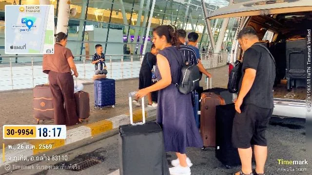 Travelers with luggage boarding a transfer van outside Phuket International Airport