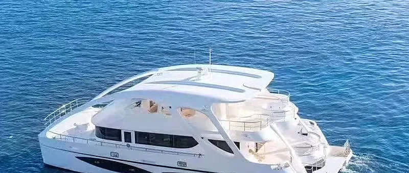 Luxury catamaran yacht sailing turquoise waters near Phi Phi Island on a Phuket island tour