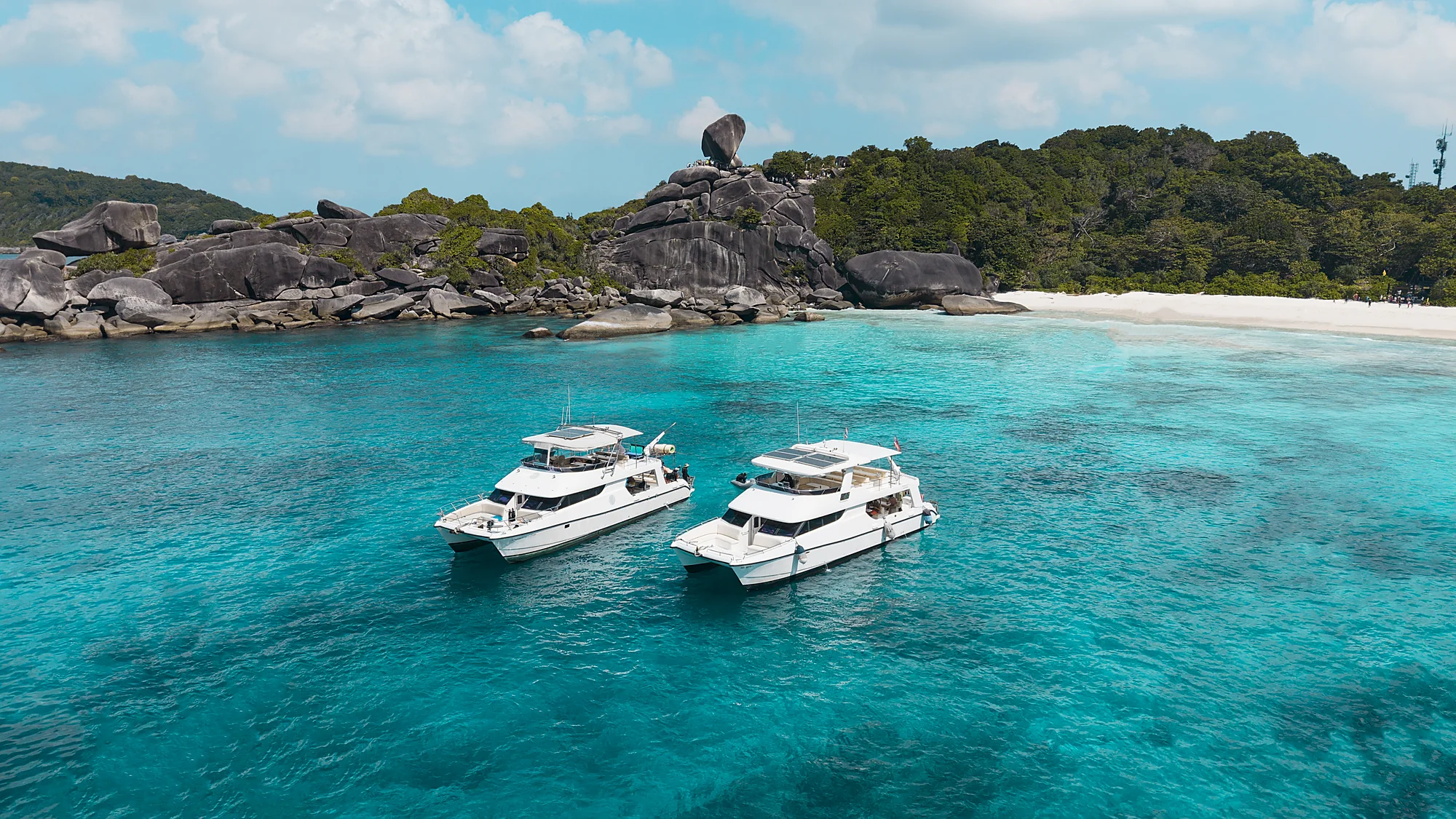 Princess Emily comfort cruise boat anchored near dramatic rock formations at Similan Islands National Park