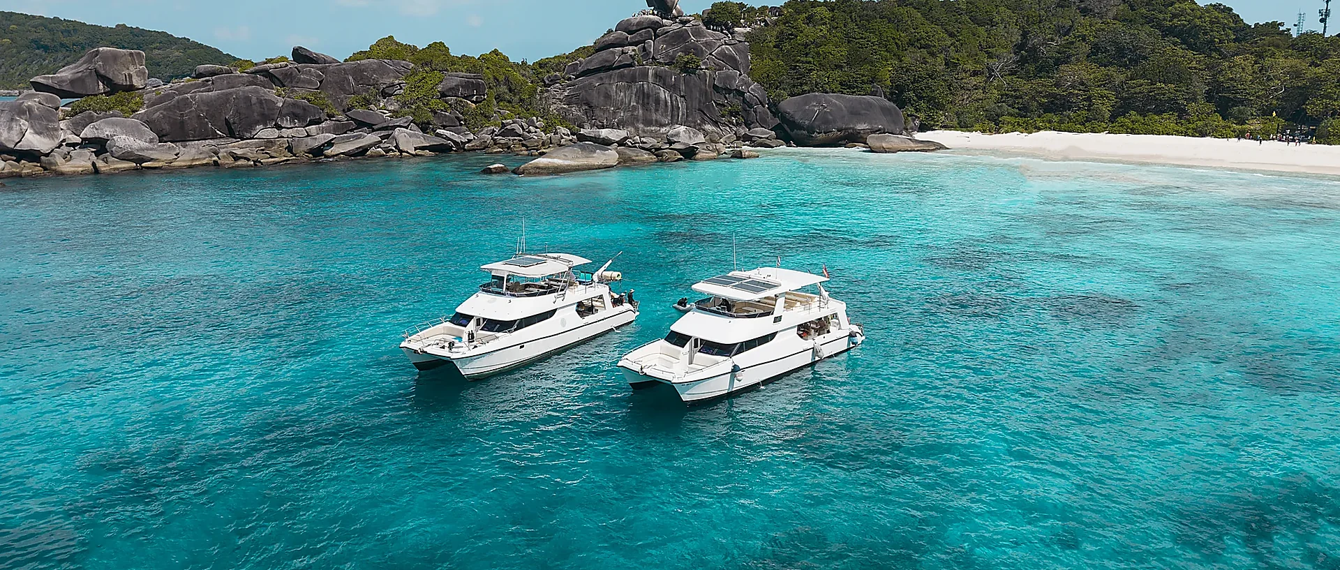 Princess Emily comfort cruise boat anchored near dramatic rock formations at Similan Islands National Park