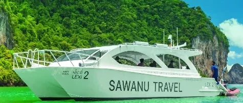 Sawanu speed catamaran cruising past James Bond Island on a day tour from Phuket