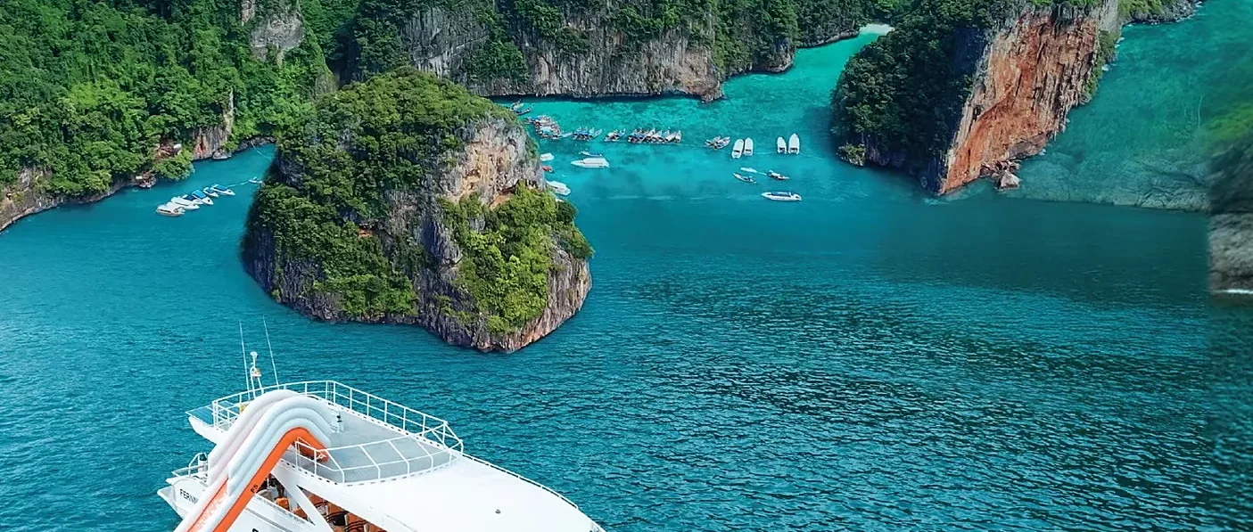 Catamaran sailing toward Phi Phi Island on a sunny day, part of a Phuket tour with lunch and transfers
